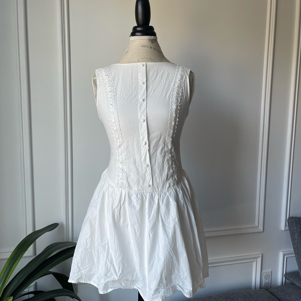 Sleeveless White Mini Dress with Button-Back and Lace Trim